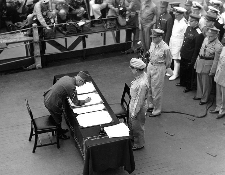 General Umezu signs the Instrument of Surrender aboard USS Missouri, photographed from overhead by Buster Campbell